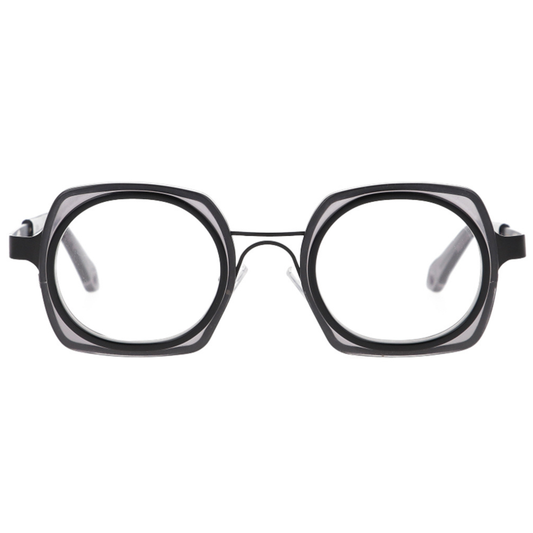 GOOD'S Taschino C C1 — Limited edition dual-geometry optical frame in matte black bio-acetate and black stainless steel, three-quarter side view showing the tie-shaped temple with thimble detail and grey acetate tip, handmade in Italy
