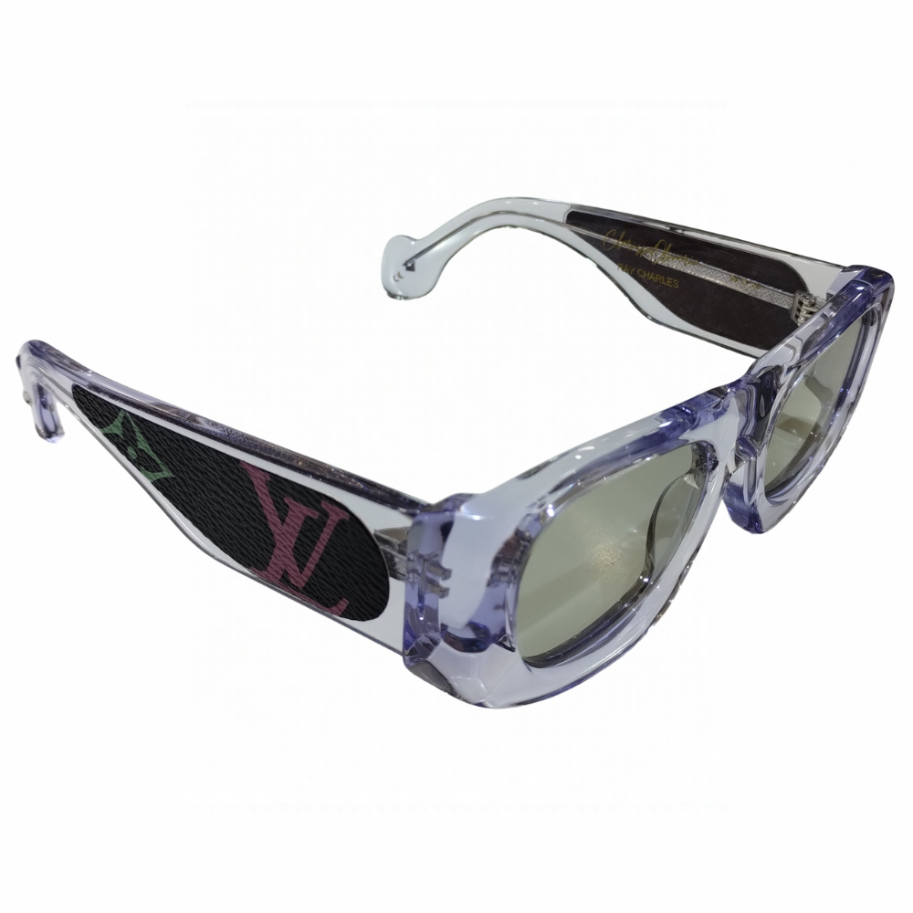 Clarissa Oliverio Mash-Up No. 02 sunglasses, three-quarter view showing the translucent acetate frame and black leather temple insert with a pink LV monogram.
