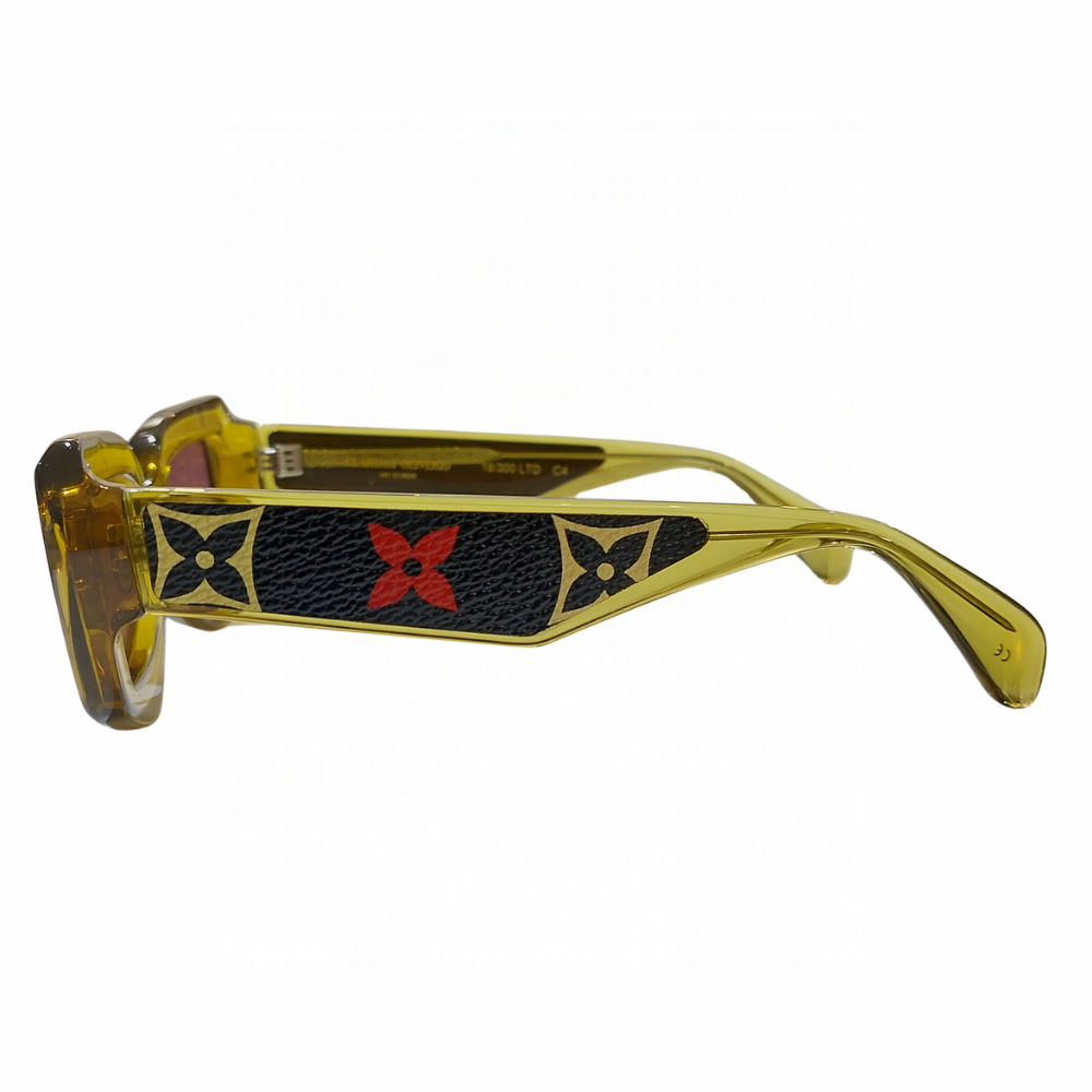 Clarissa Oliverio San Lorenzo Mash-Up LV sunglasses, side view showing a yellow acetate temple with black leather and yellow and red floral monogram motifs.
